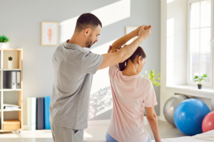 Physical therapist helping a patient with sciatica stretches for acute sciatica pain relief